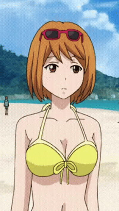 A Girl In A Yellow Bikini And Red Sunglasses Stands On The Beach GIF