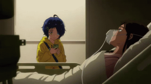 A Girl In A Yellow Hoodie Is Standing Next To A Woman In A Hospital Bed With An Oxygen Mask On Her Face GIF