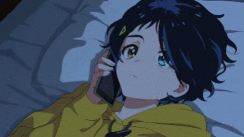 A Girl In A Yellow Hoodie Is Talking On A Phone GIF
