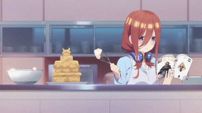 A Girl In An Apron Is Reading A Magazine While Cooking GIF