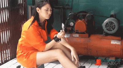 A Girl In An Orange Jumpsuit Sits Next To An Air Compressor With The Words Collaboration Project On The Bottom GIF