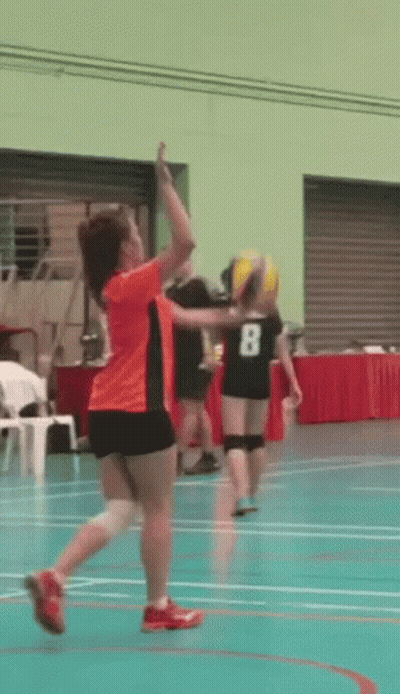 A Girl In An Orange Shirt With The Number 8 On Her Back GIF