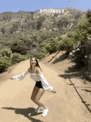 A Girl In The Mountains Jumping For Joy GIF