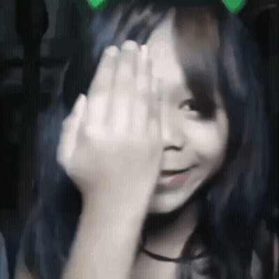 A Girl Is Covering Her Face With Her Hand . GIF