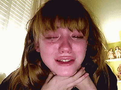 A Girl Is Crying With Her Eyes Closed And Her Mouth Open GIF