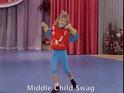 A Girl Is Dancing On A Stage And The Words Middle Child Swag Are On The Bottom Of The Screen GIF
