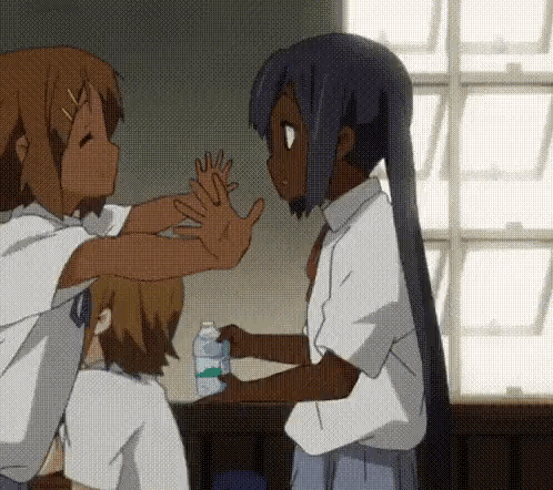 A Girl Is Giving A High Five To Another Girl Who Is Holding A Bottle Of Milk GIF