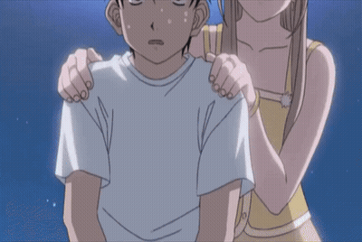 A Girl Is Holding A Boy 'S Shoulders In A Cartoon GIF