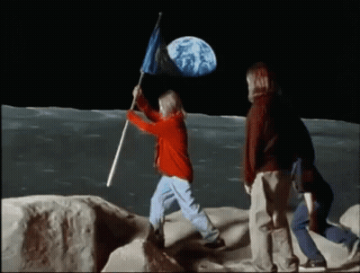 A Girl Is Holding A Flag On The Moon GIF