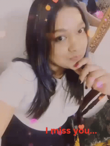 A Girl Is Holding Her Finger To Her Lips With The Words I Miss You Written In Red GIF