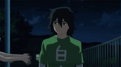 A Girl Is Hugging A Boy With A Green Shirt That Says T On It GIF