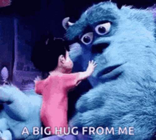 A Girl Is Hugging A Stuffed Animal From Monsters Inc . GIF