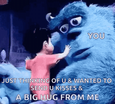 A Girl Is Hugging A Stuffed Monster From Monsters Inc . GIF