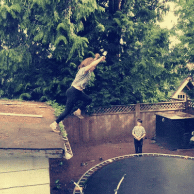 A Girl Is Jumping On A Trampoline While A Boy Looks On GIF