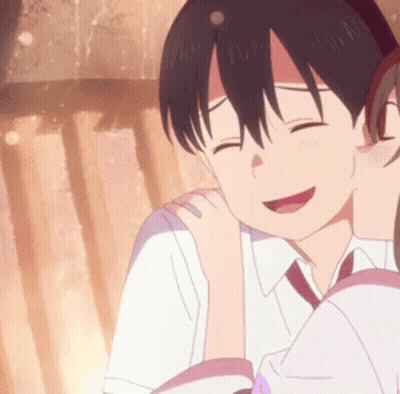 A Girl Is Kissing A Boy On The Cheek And They Are Smiling . GIF