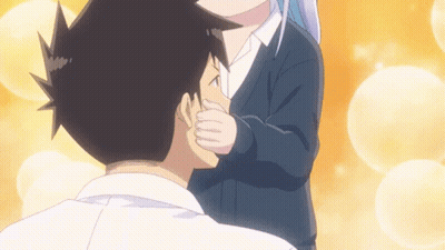 A Girl Is Kissing A Boy On The Cheek GIF