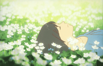 A Girl Is Laying In A Field Of Flowers With Her Eyes Closed GIF