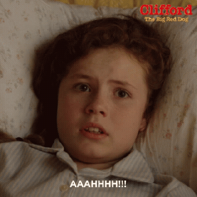 A Girl Is Laying In Bed With Clifford The Big Red Dog GIF