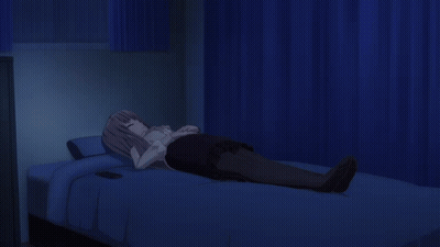 A Girl Is Laying On A Bed With A Cell Phone On The Bed GIF