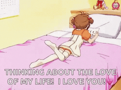 A Girl Is Laying On A Bed With Her Legs Crossed And Reading A Book . GIF
