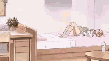 A Girl Is Laying On Her Stomach On A Bed In A Room With A Desk And A Table . GIF