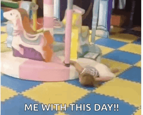 A Girl Is Laying On The Floor Next To A Merry Go Round And The Words Me With This Day GIF