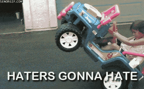 A Girl Is Riding A Toy Jeep That Says Haters Gonna Hate On The Bottom GIF
