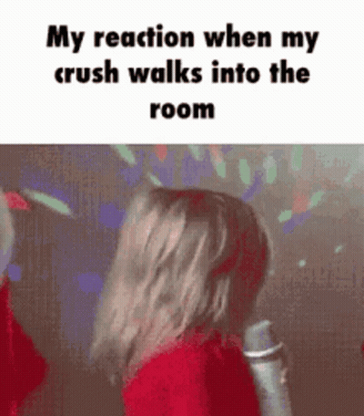 A Girl Is Singing Into A Microphone In A Room . GIF