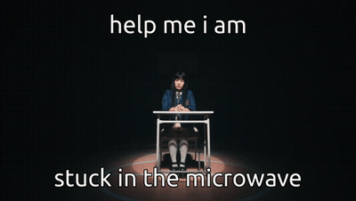 A Girl Is Sitting At A Desk With The Words Help Me I Am Stuck In The Microwave Below Her GIF