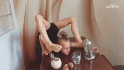 A Girl Is Sitting At A Table With Her Legs Crossed And A Pitcher Of Water . GIF