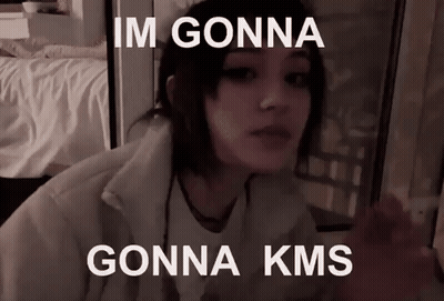 A Girl Is Sitting In Front Of A Window With The Words `` Im Gonna Gonna Kms '' On Her Face . GIF