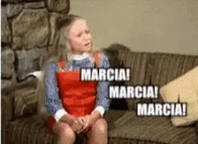 A Girl Is Sitting On A Couch With The Words Marcia GIF