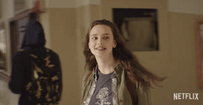 A Girl Is Smiling In A Hallway With A Netflix Logo In The Corner GIF
