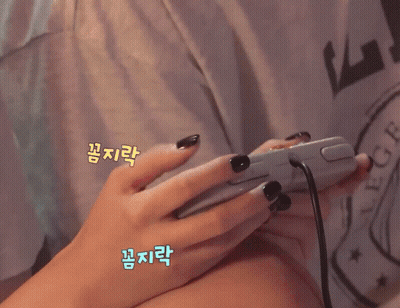A Girl Is Smiling While Playing A Video Game GIF