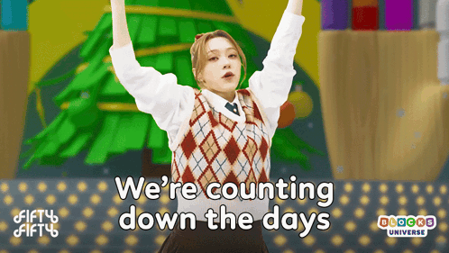 A Girl Is Standing In Front Of A Christmas Tree With The Words We 'Re Counting Down The Days Above Her GIF