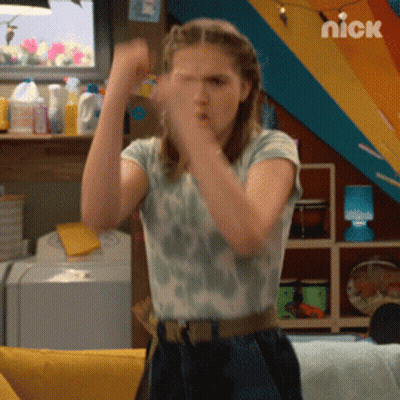 A Girl Is Standing In Front Of A Nickelodeon Logo GIF
