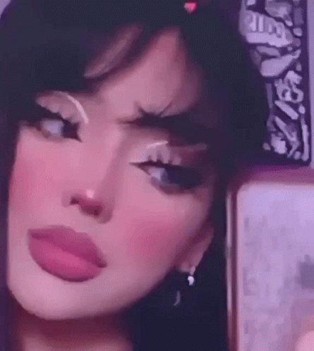 A Girl Is Taking A Selfie In Front Of A Mirror . GIF