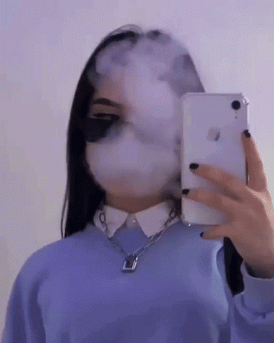 A Girl Is Taking A Selfie With Her Phone While Smoking A Cigarette . GIF