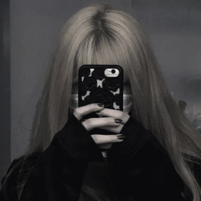 A Girl Is Taking A Selfie With Her Phone While Wearing A Mask . GIF