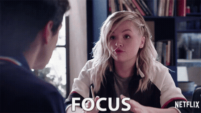 A Girl Is Talking To A Man And The Word Focus Is On The Screen GIF