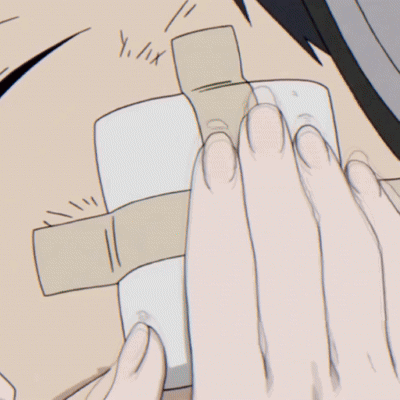 A Girl Is Touching A Boy 'S Face With Her Hand GIF
