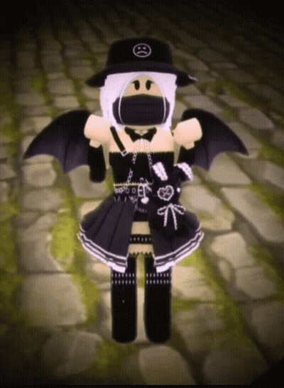 A Girl Is Wearing A Black Hat And A Black Dress With Wings . GIF