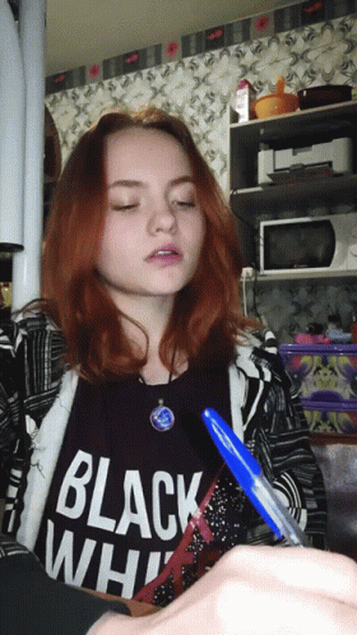 A Girl Is Wearing A Black Shirt That Says Black White GIF