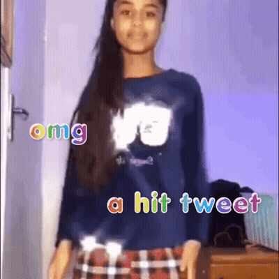 A Girl Is Wearing A Blue Shirt And Plaid Skirt And Says Omg A Hit Tweet GIF