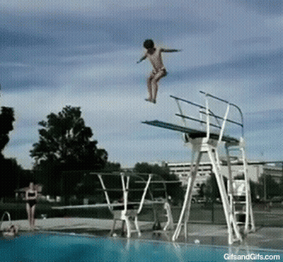 A Girl Jumps Off A Diving Board Into A Swimming Pool GIF