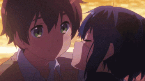A Girl Kissing A Boy On The Cheek In A Cartoon GIF