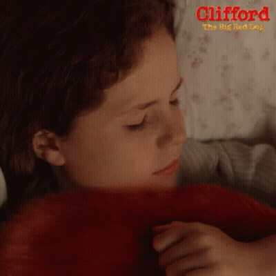 A Girl Laying In Bed With A Red Blanket And The Words Clifford The Big Red Dog GIF