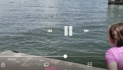 A Girl Looks Out Over A Body Of Water With A Pause Button In The Corner GIF