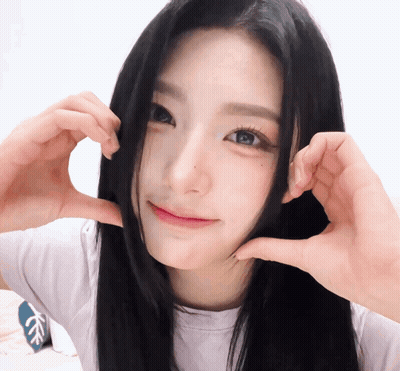A Girl Making A Heart Shape With Her Hands GIF