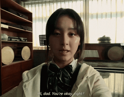 A Girl Says Hi Dad You 'Re Okay Right In Front Of A Window GIF